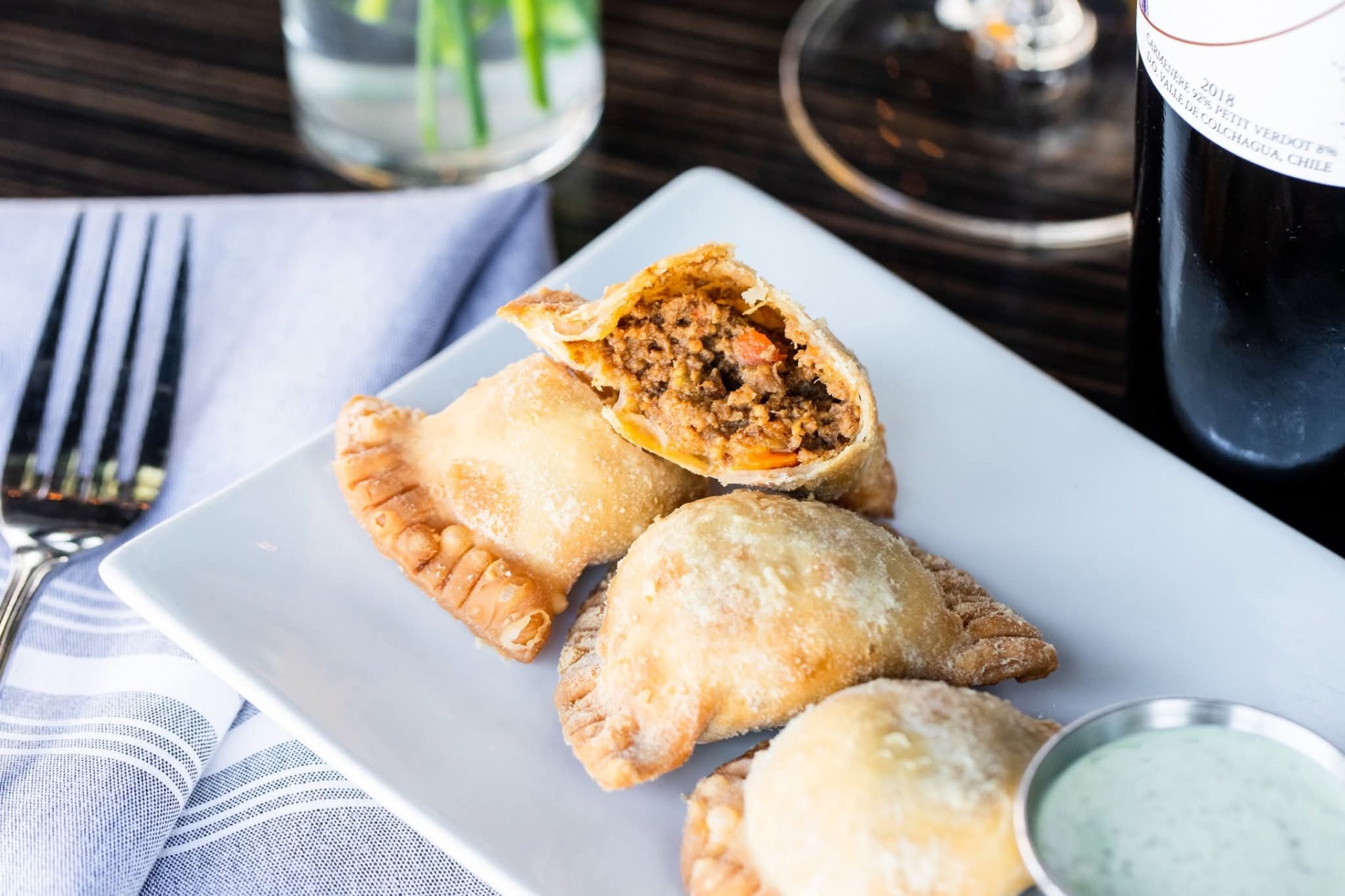 Beef empanadas with herbed dipping sauce and a glass of Chilean red at D'Vine Wine Bar